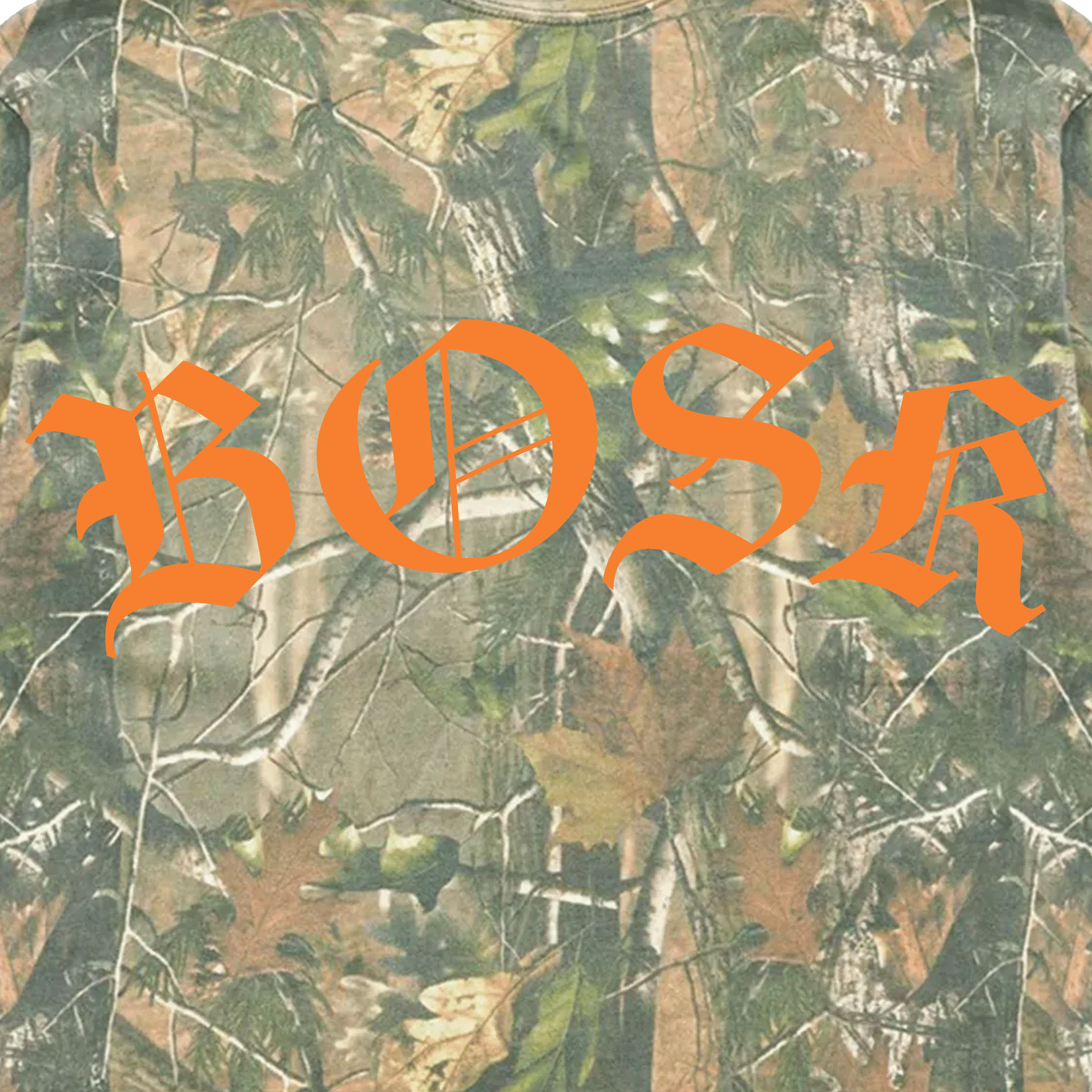 The BOSK Camo Tee features a forest-like, camouflage background with leaves and branches. The brand name "BOSK" is boldly showcased in large, orange, Gothic-style letters across the center for a striking contrast.