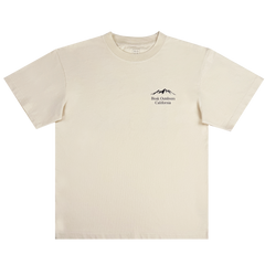 The Bosk Outdoors Tee by BOSK is a cream-colored, short-sleeve T-shirt with a round neckline. It features a minimalist design with a small black mountain graphic and "Book Outdoors California" text on the left chest, offering a simple and casual style.