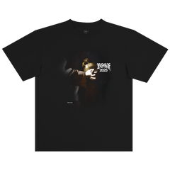 The BOSK St. Francis Tee is a black heavy-weight 100% cotton classic fit shirt with a dark image of hands holding a glowing object and “ROSE 2025” in stylized white font, creating a mysterious, dramatic look.