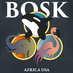 The Bosk World Tee by BOSK features a stylized orca overlapping two circles—one with an elephant on a savanna, one with a pink flamingo. Large "BOSK" text sits above, "AFRICA USA" below. Printed on heavy-weight 100% cotton; dark gray background.
